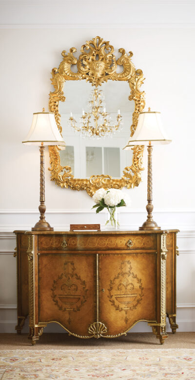 Gilt mirror above marquetry commode